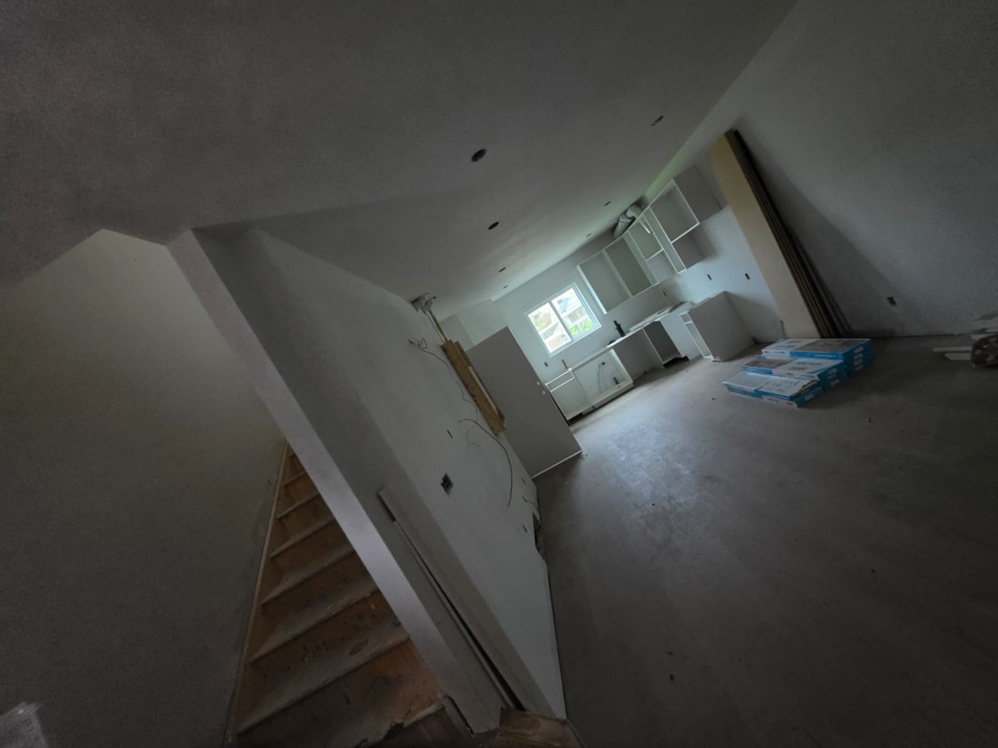 8-Plex Sherwood Park — Stair core & great room, August 2026