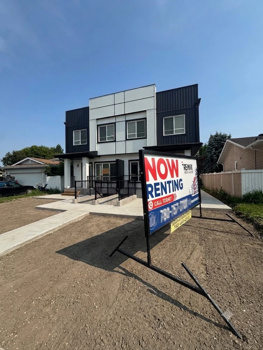 A recently completed Multi Family Deals build in Edmonton with a 'Now Renting' sign out front — property management marketing the units before closing.