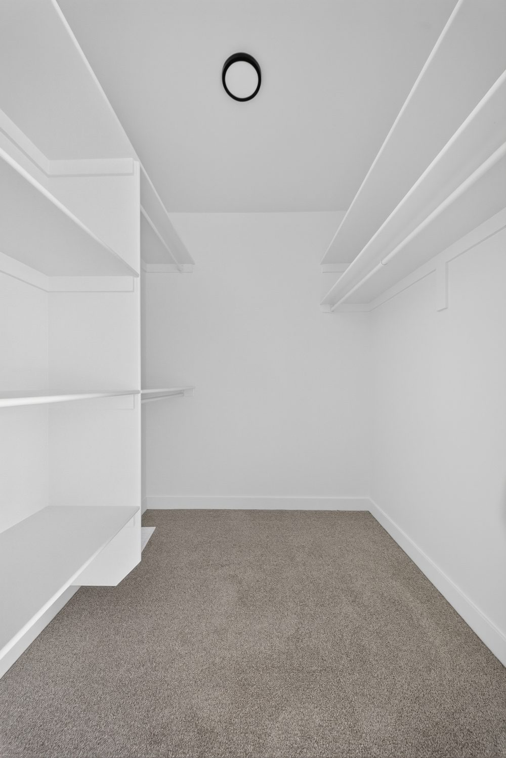Bedroom closet with shelving and hanging rails